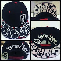 a black and white snapback hat with graffiti on it